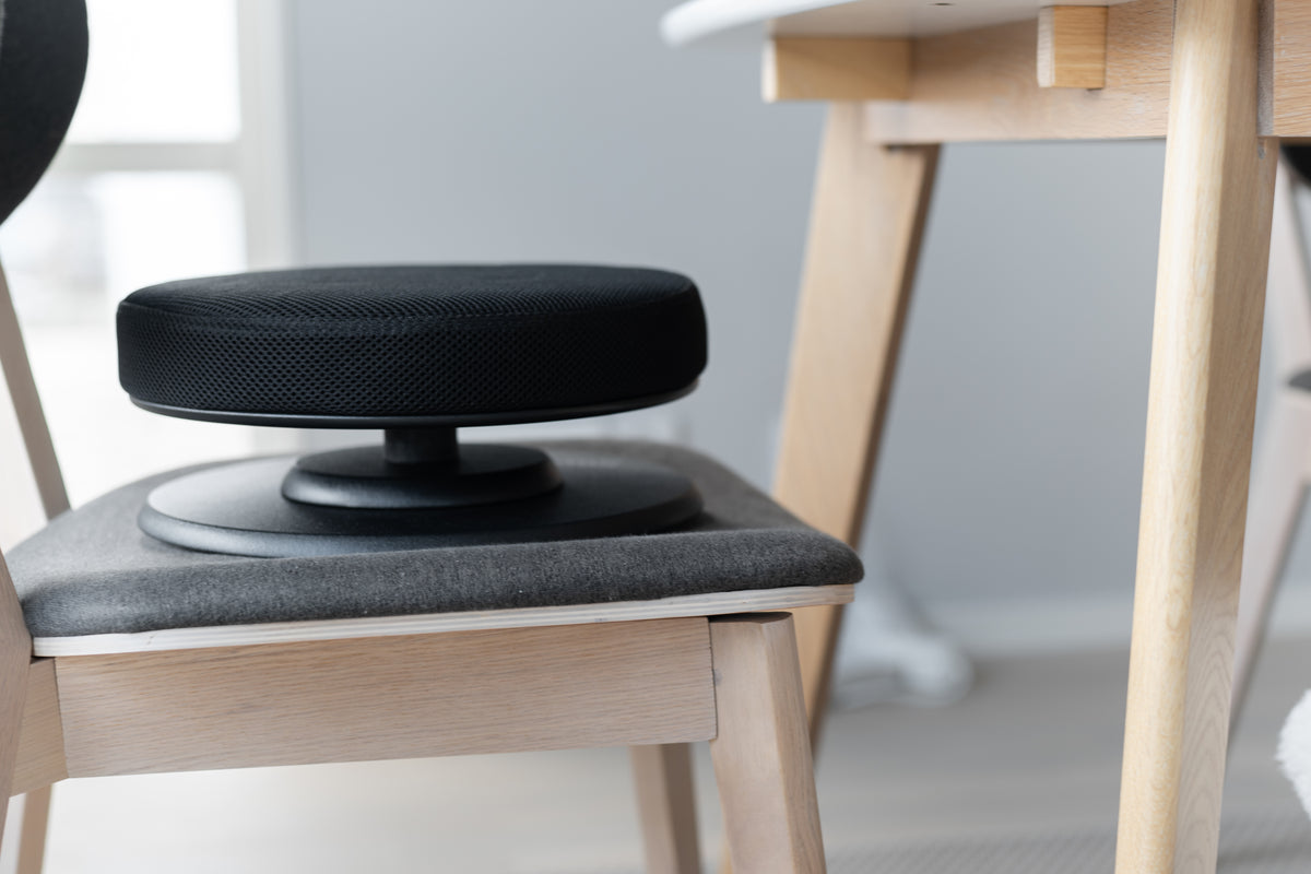 Posture balance active seat cushion placed on a wooden chair