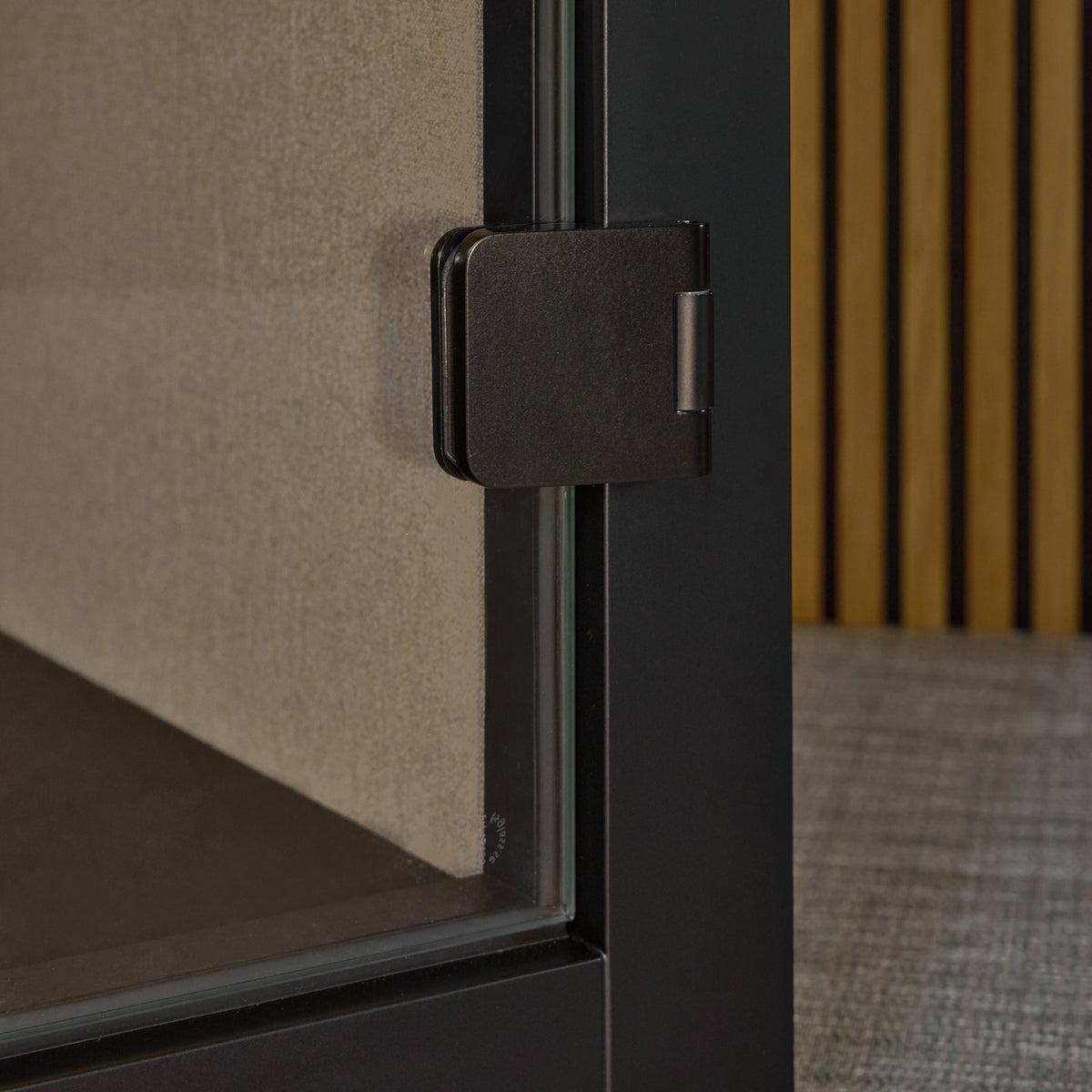 Close-up of the door handle and hinge on the Focus Pod phone booth