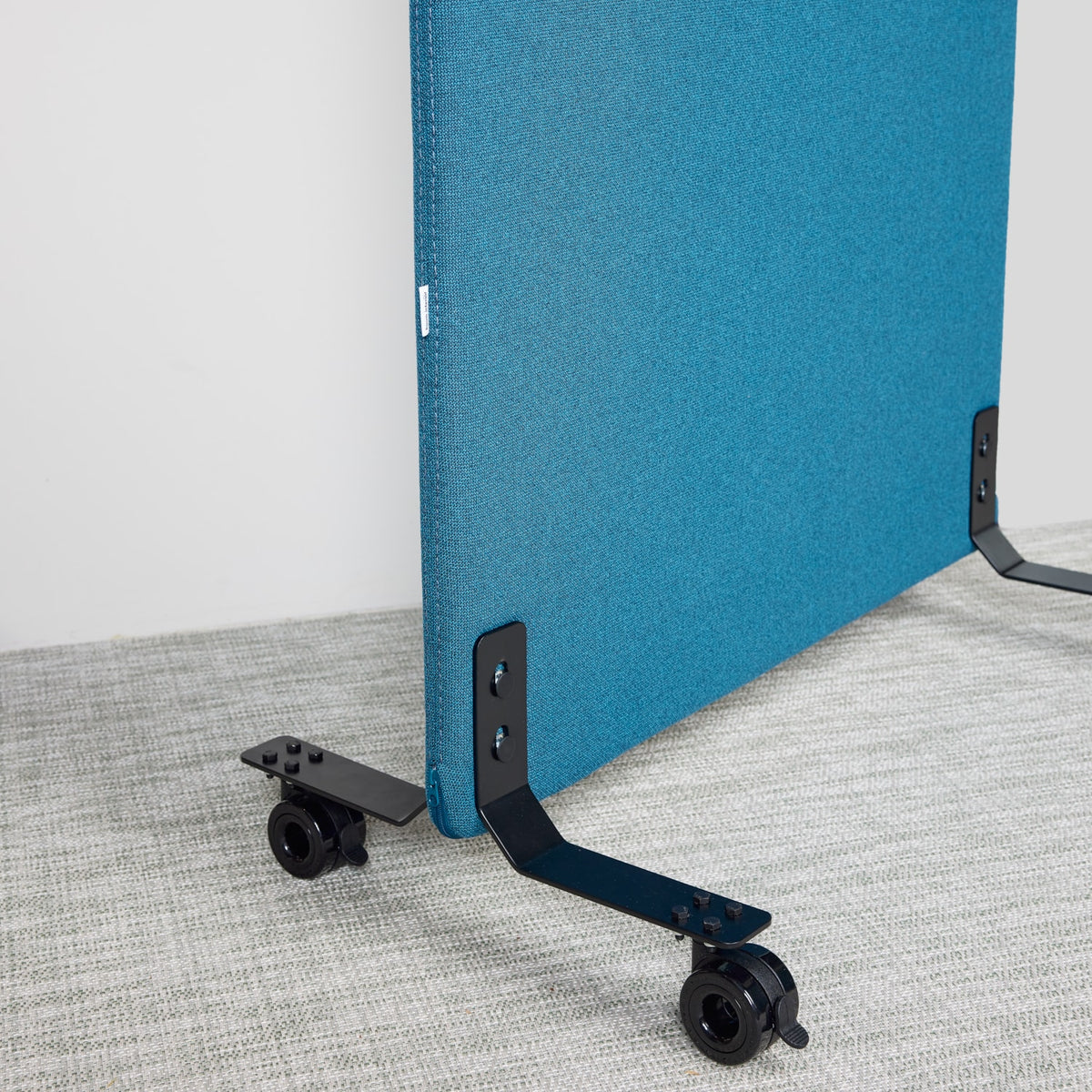 Blue floor screen standing on wheeled feet, seen from the base
