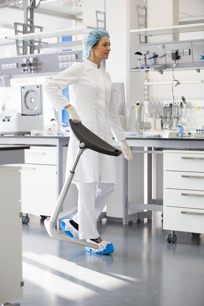 Laboratory worker seated on a FIN leaning chair at a clean room workstation