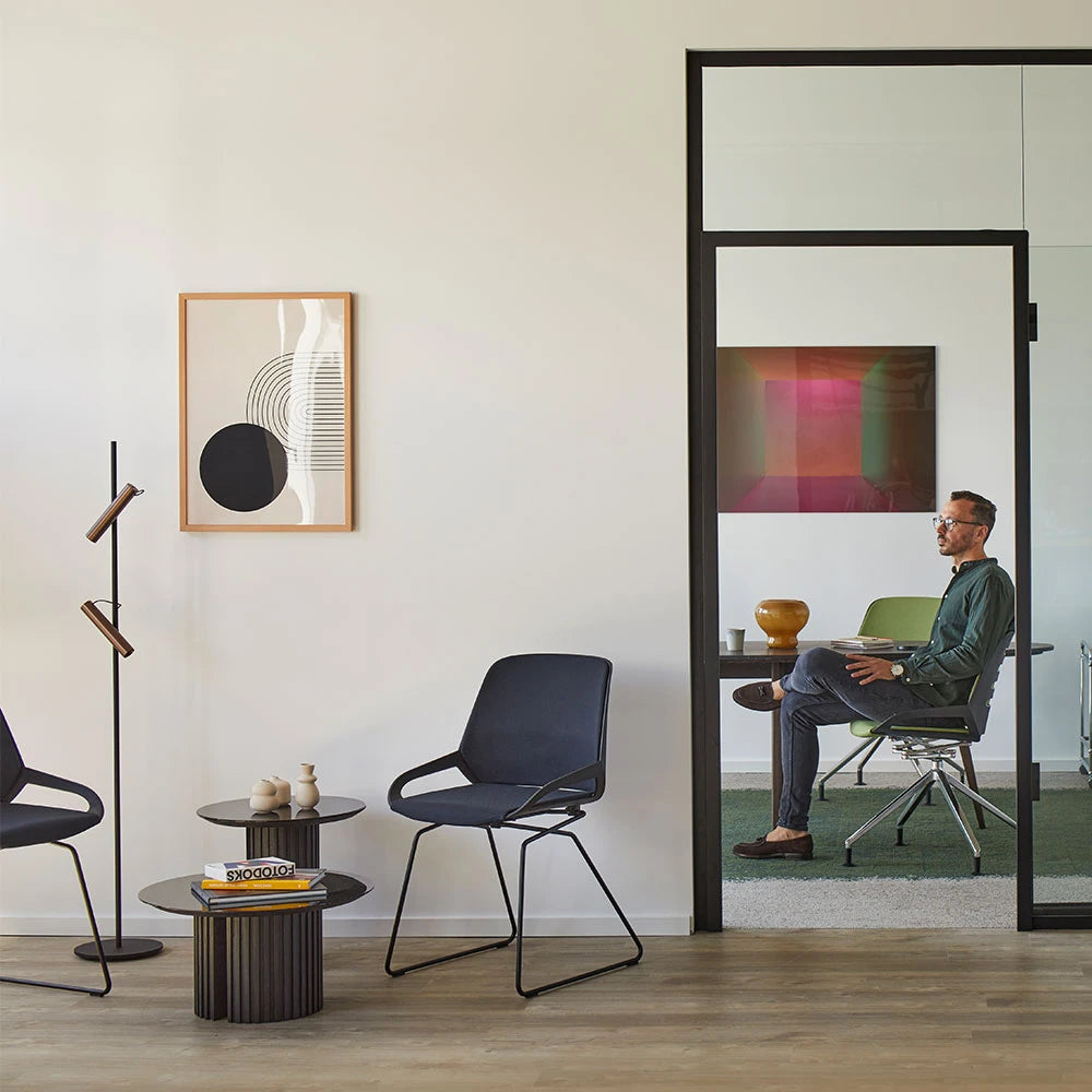 Numo Comfort chairs with skid bases in a bright interior with a coloured wall