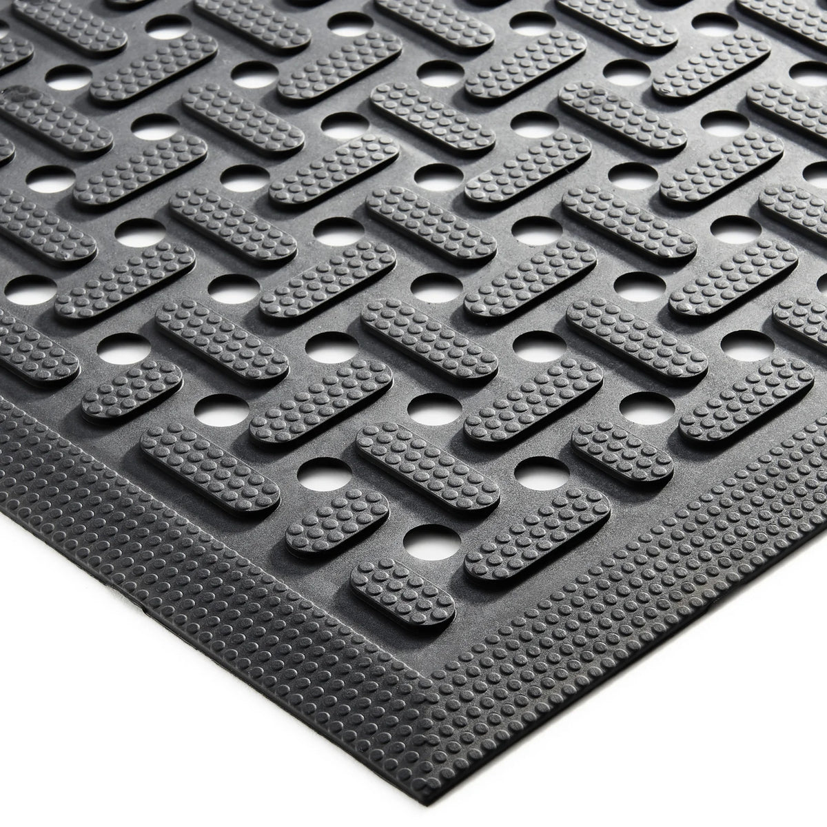 Close-up of the raised nitrile surface of a black workstation mat