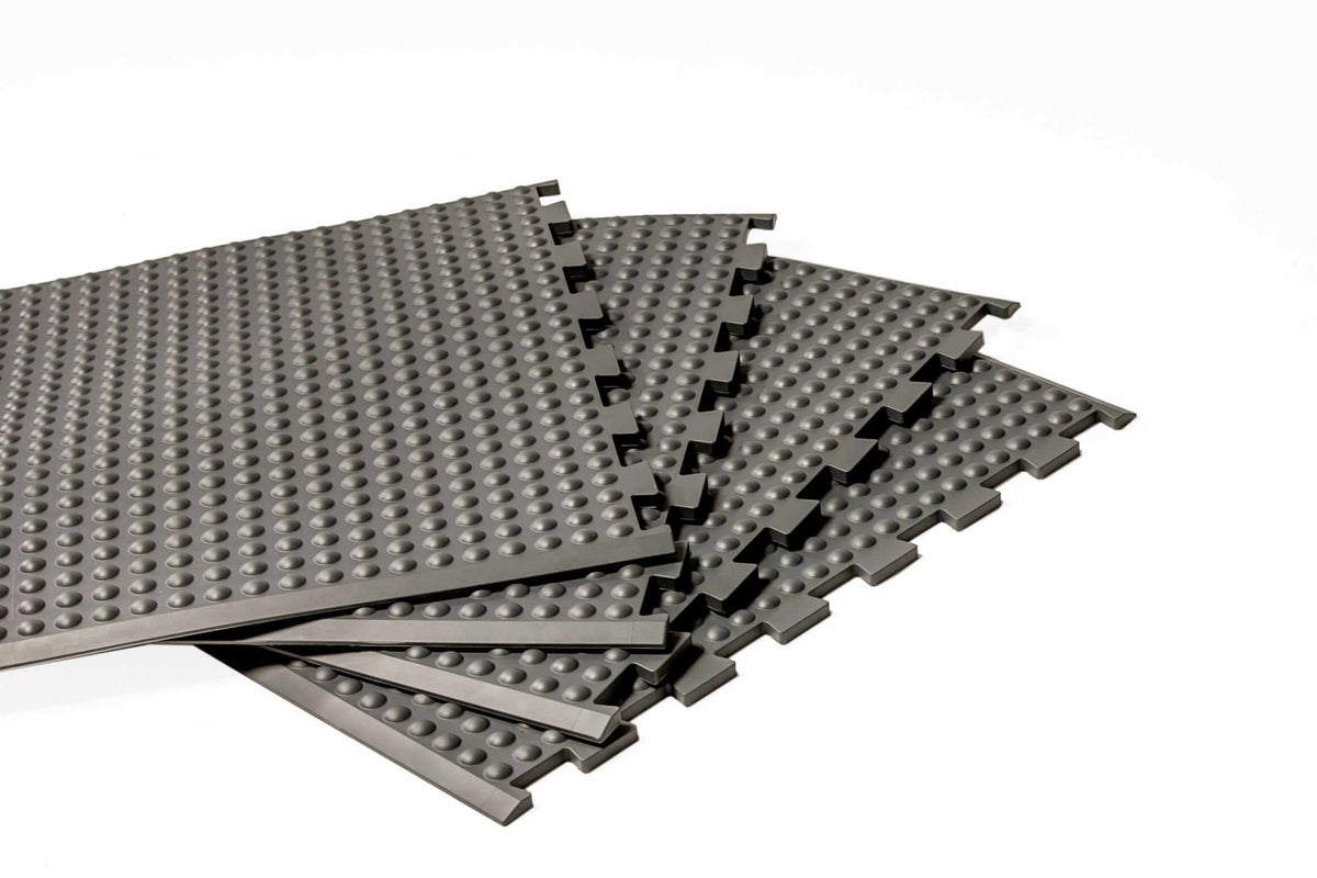 Grey GetUpMat Puzzle extension pieces for customizable ergonomic standing mat solutions.