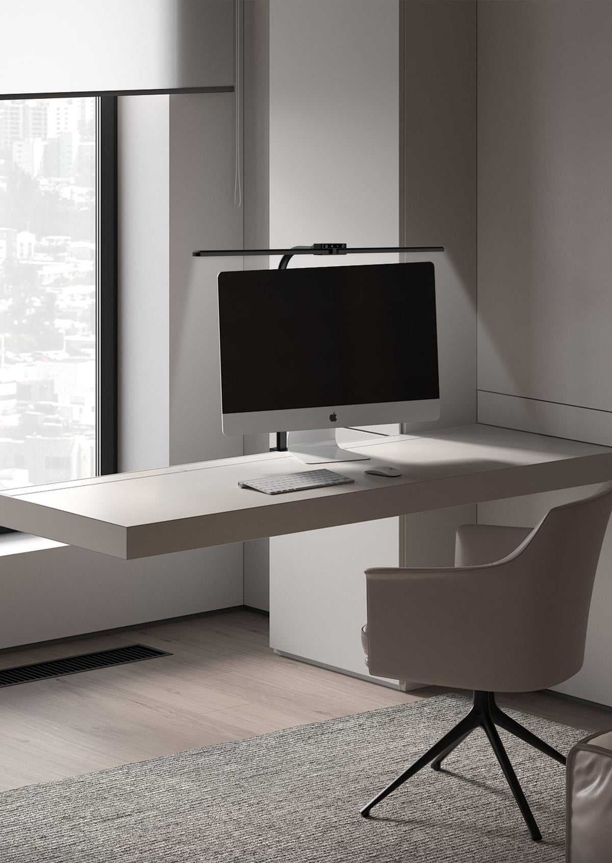 Office desk with a monitor lit by a DUO LED desk lamp
