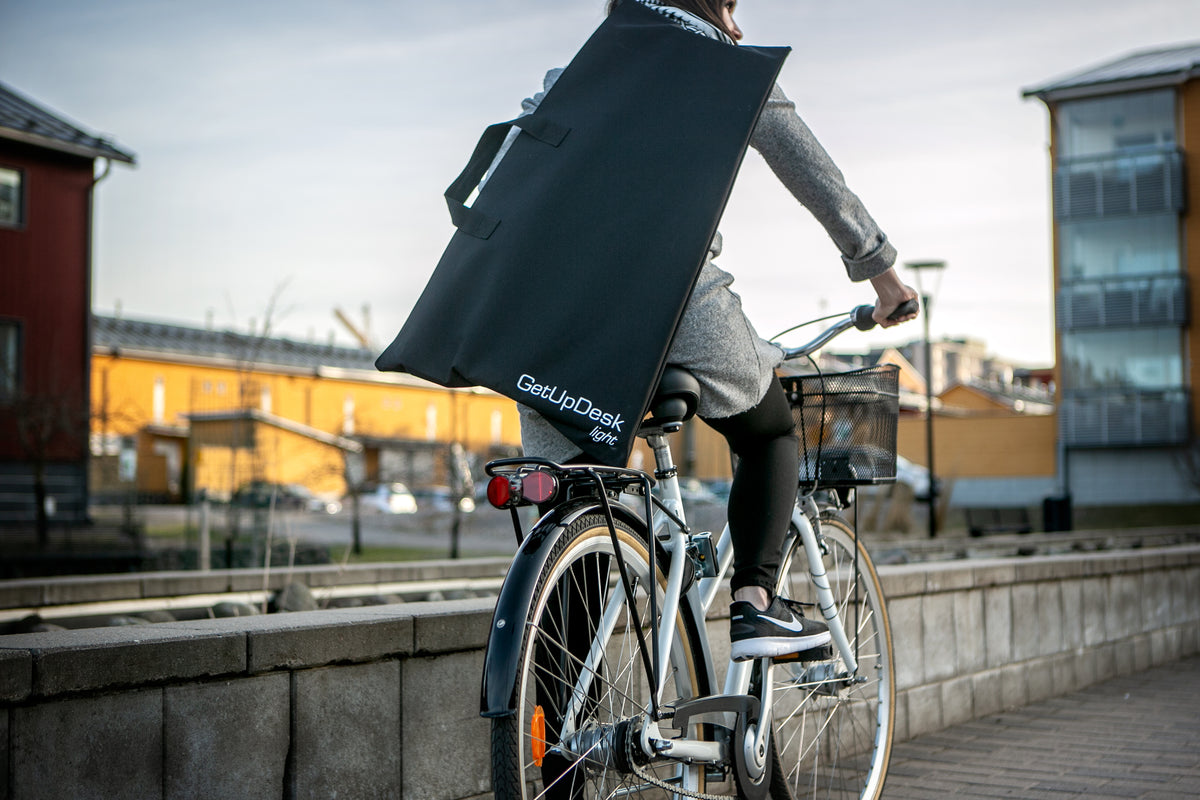 GetUpDesk Light stand strapped to a bicycle rack outdoors