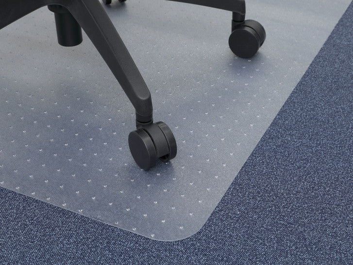 Chair castor on a transparent spiked chair mat laid over carpet