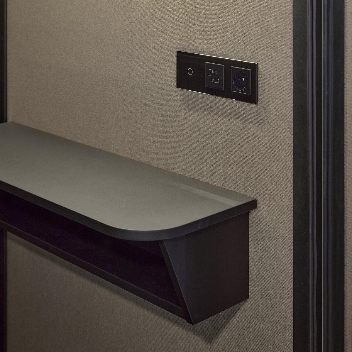 Interior of the Focus Pod phone booth showing the seat and worktop