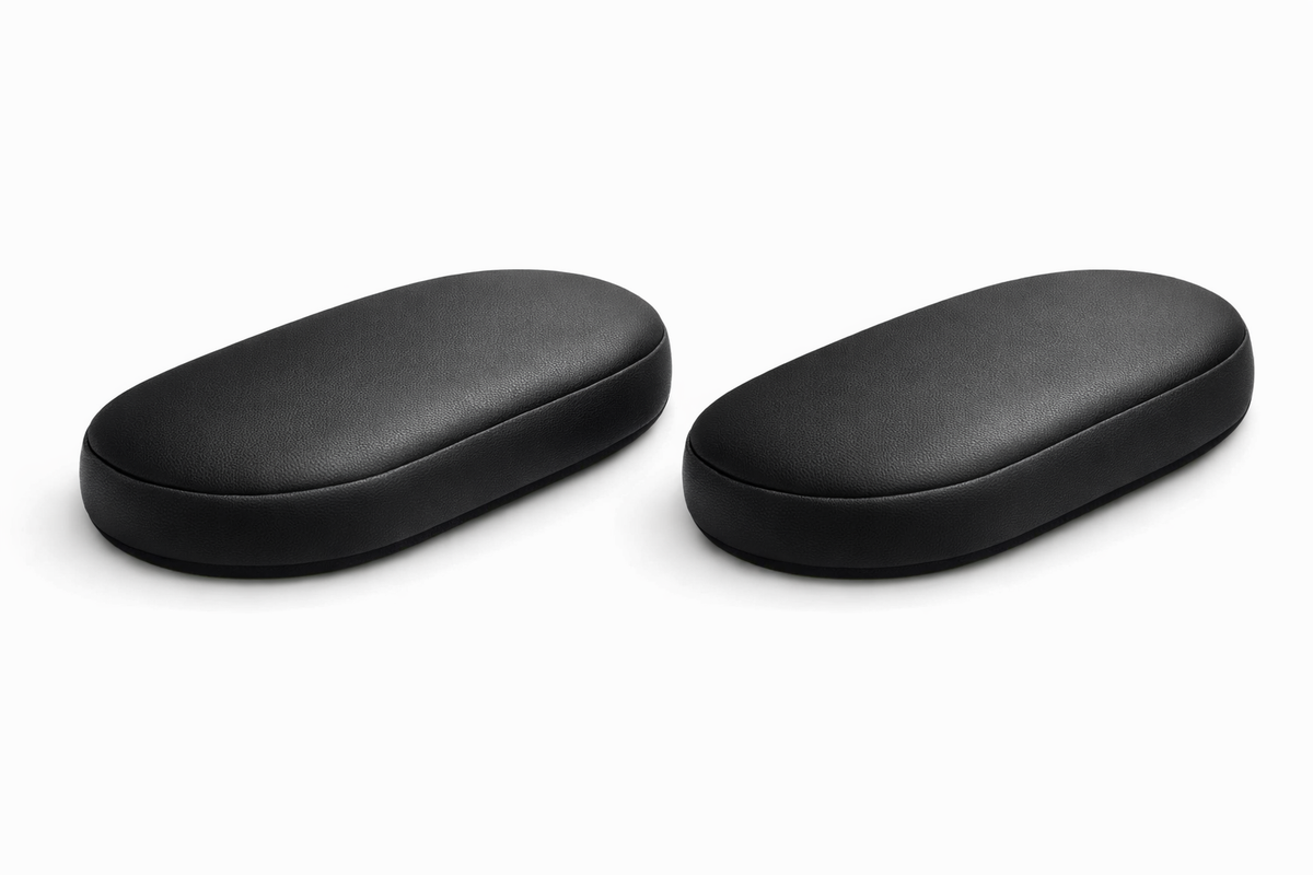 Pair of black faux leather armrest pads shown side by side