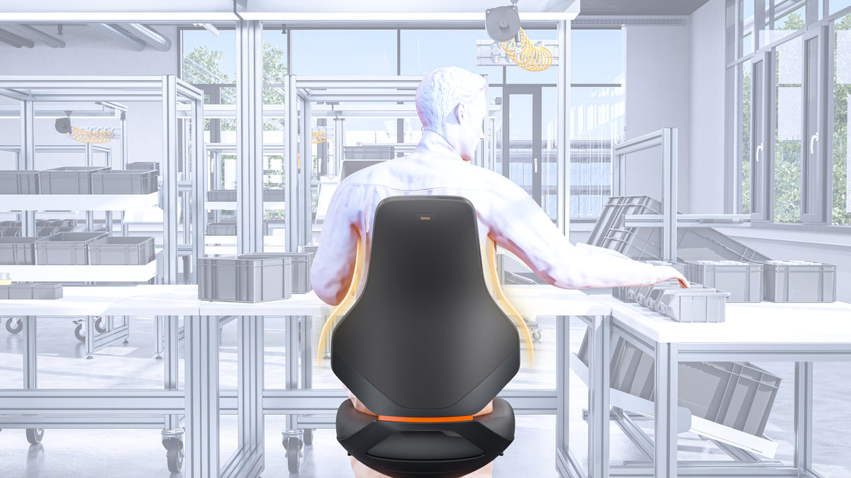 Worker seen from behind seated on a Texon work chair at a production bench
