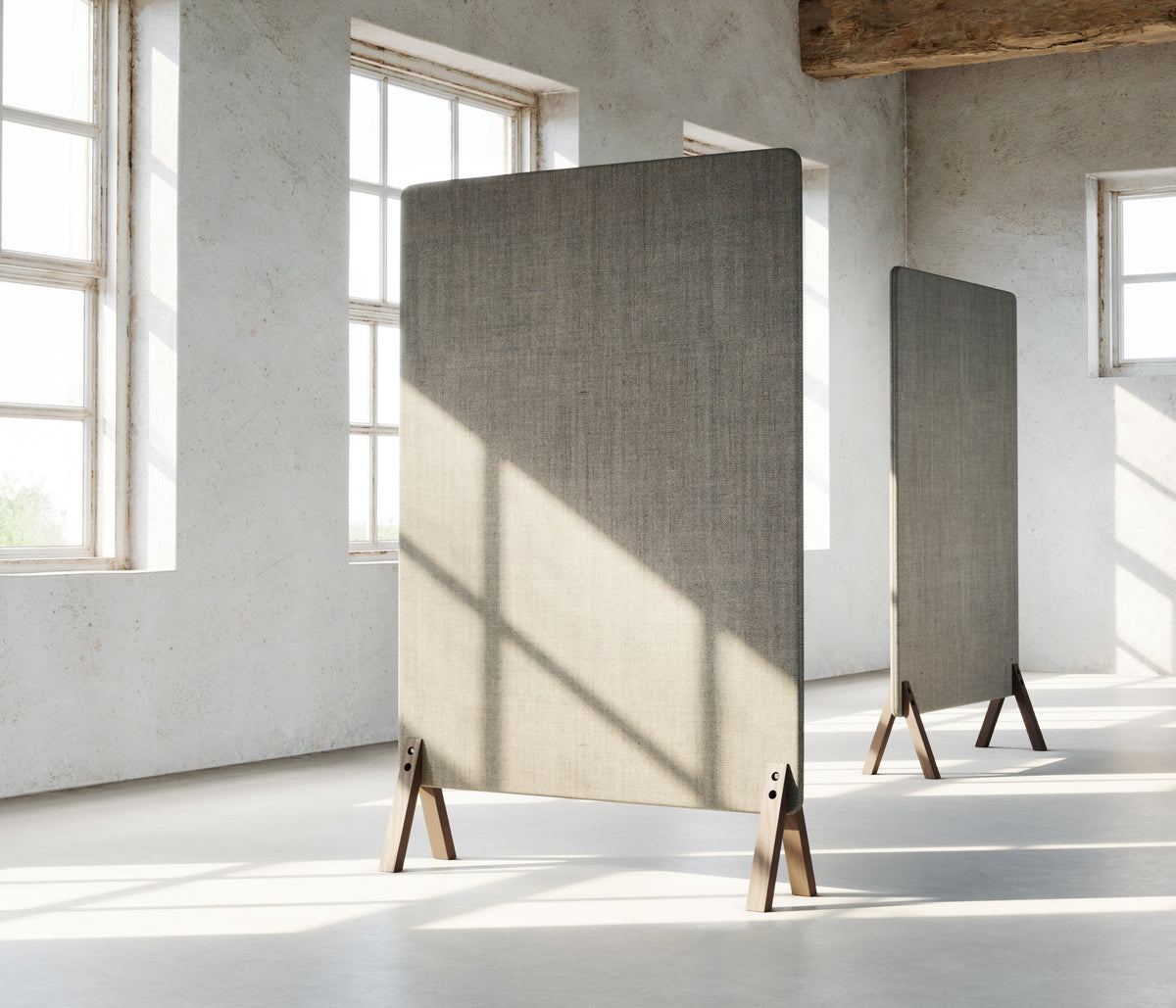 Room divided by fabric floor screens standing on ash coloured wooden feet