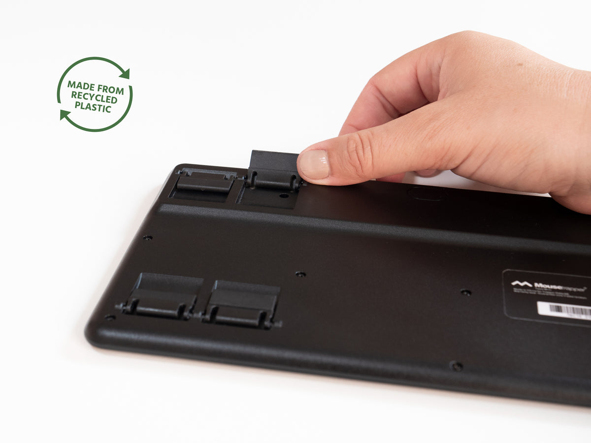 Hand adjusting the fold-out feet on the underside of the Type Mini keyboard