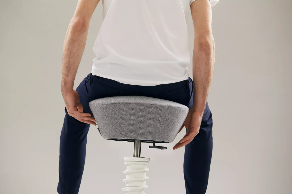 Close-up of a person seated on a Swopper active chair seat