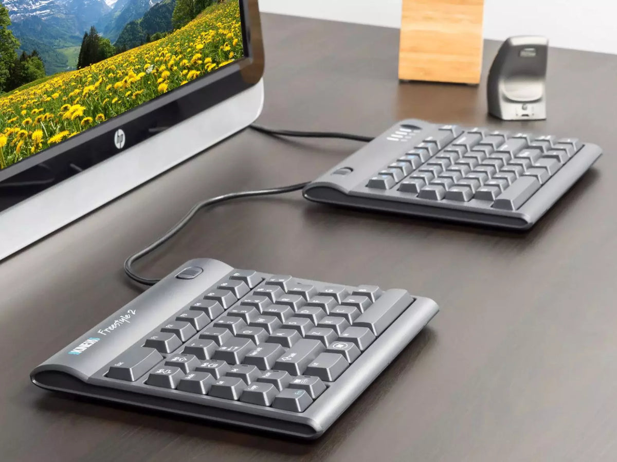 Office desk with a Freestyle 2 split keyboard, monitor and mouse