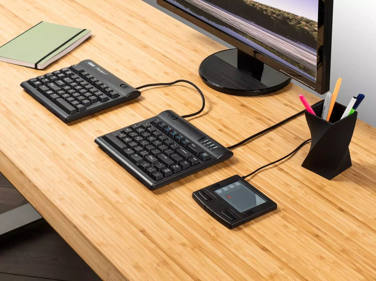 Wooden desk with a Freestyle 2 split keyboard and monitor