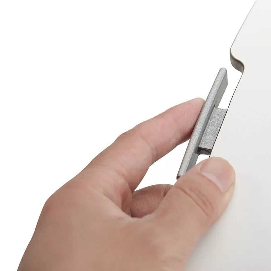 Hand gripping the release handle under the GetUpDesk Free tabletop