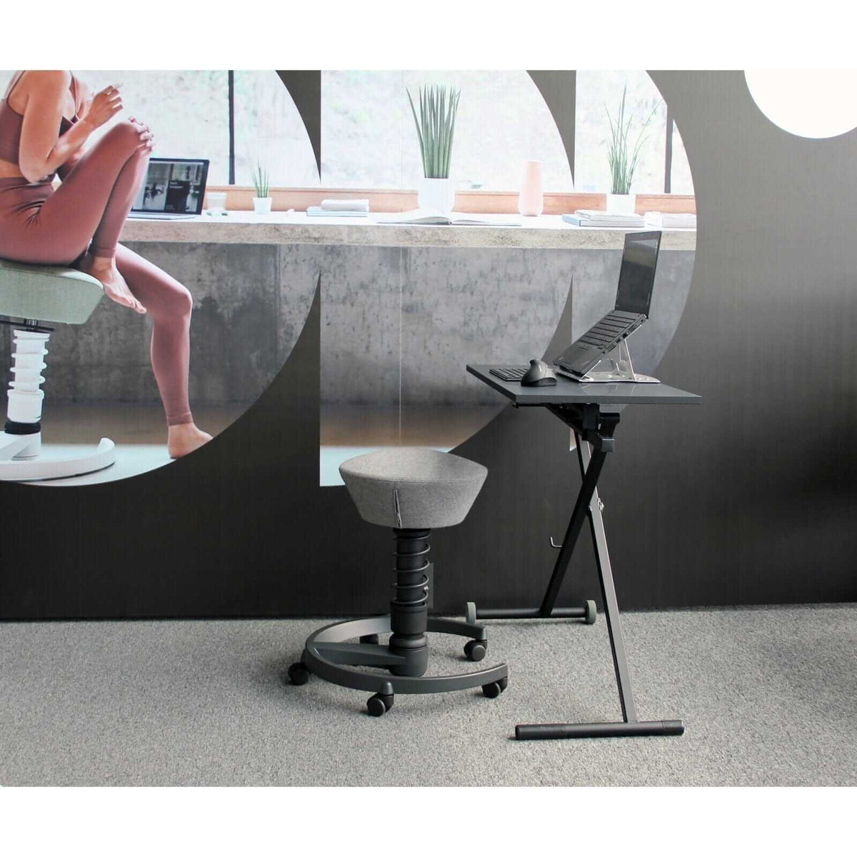 GetUpDesk Move desk set up beside a round window in an office