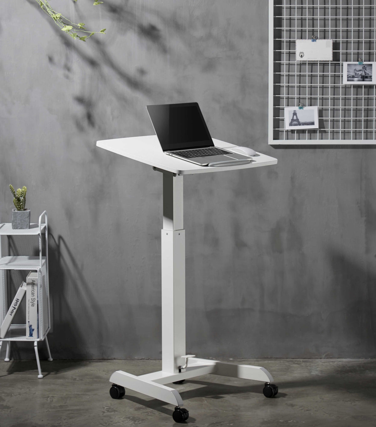 White GetUpDesk Tilt desk raised to standing height with a laptop