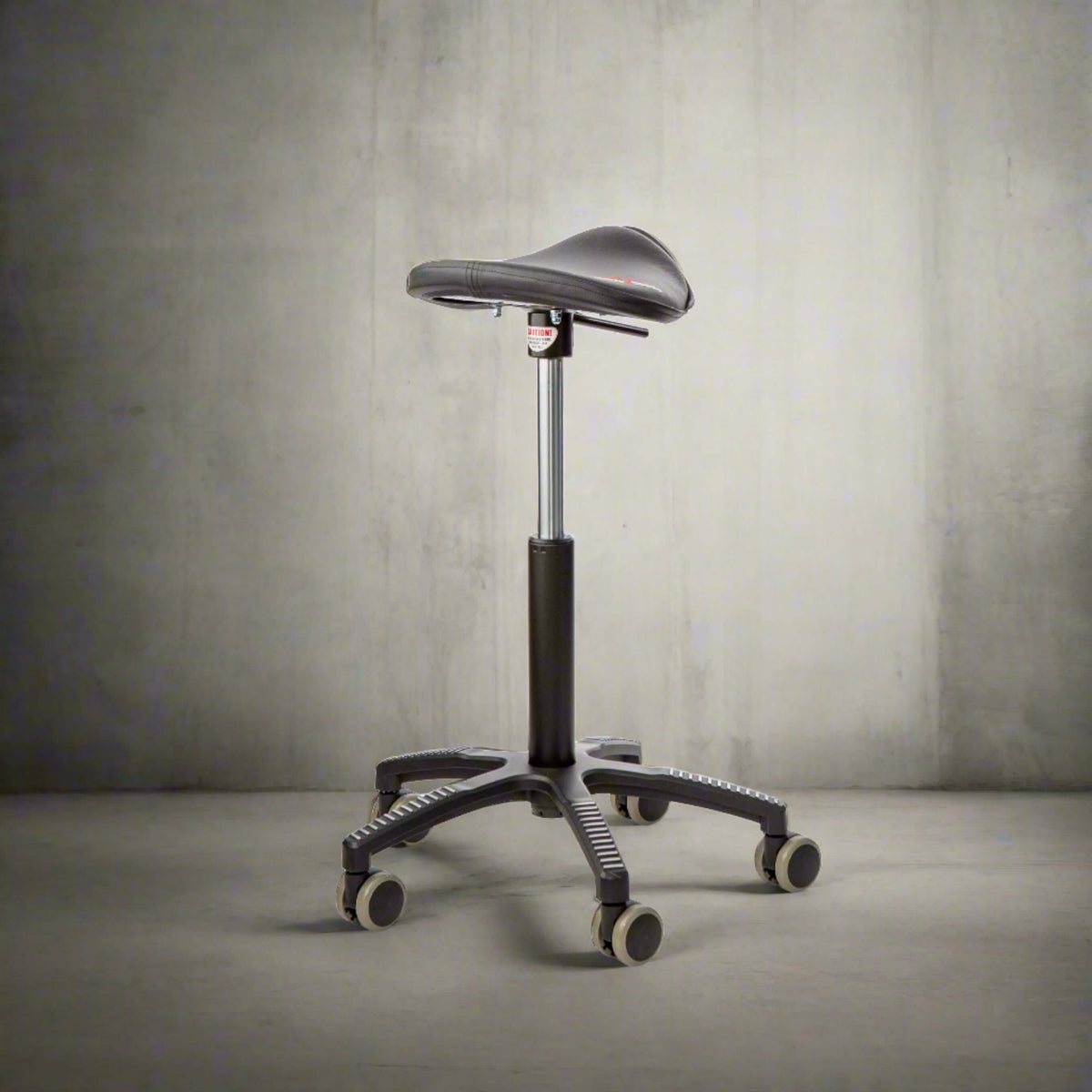 GetUpSaddle chair photographed against a dark textured background
