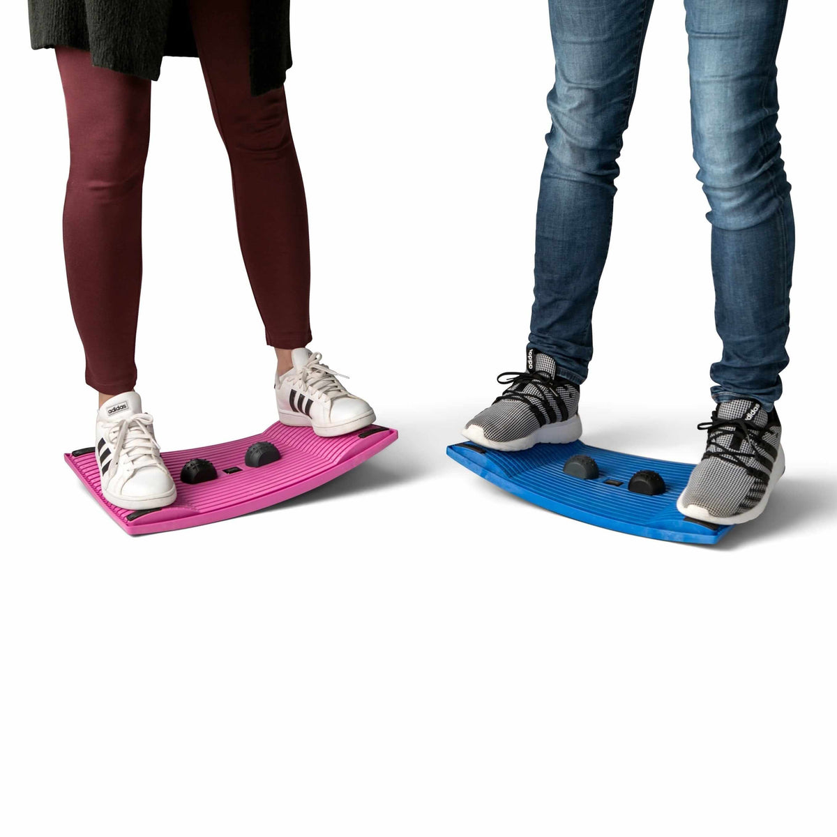 Two people standing on colorful activation boards for workplace movement and exercise.